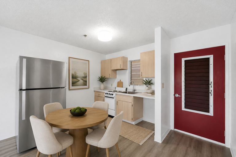 Dining area with kitchen and red front door