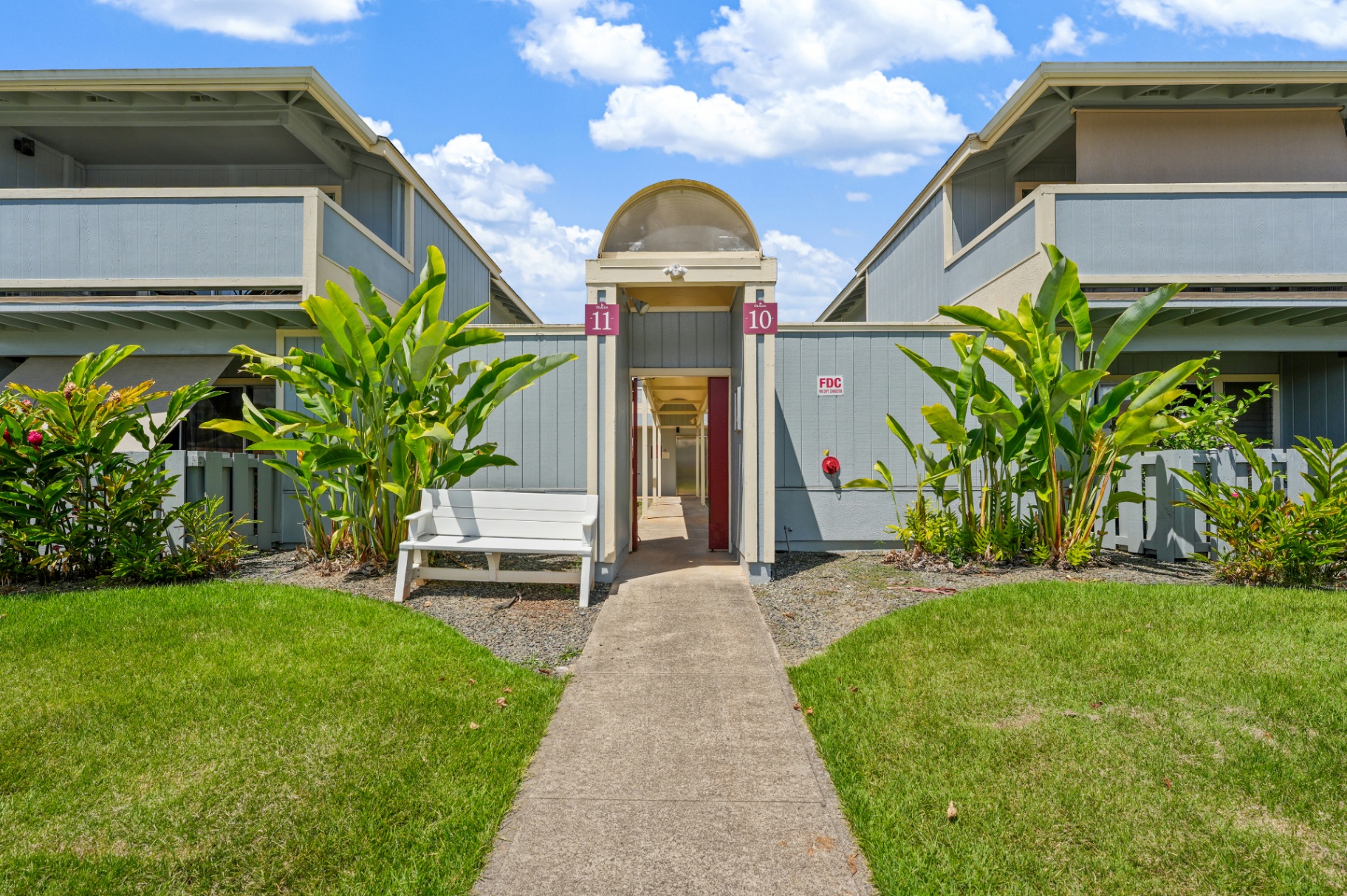 Building 10 walkway entrance with tropical landscaping
