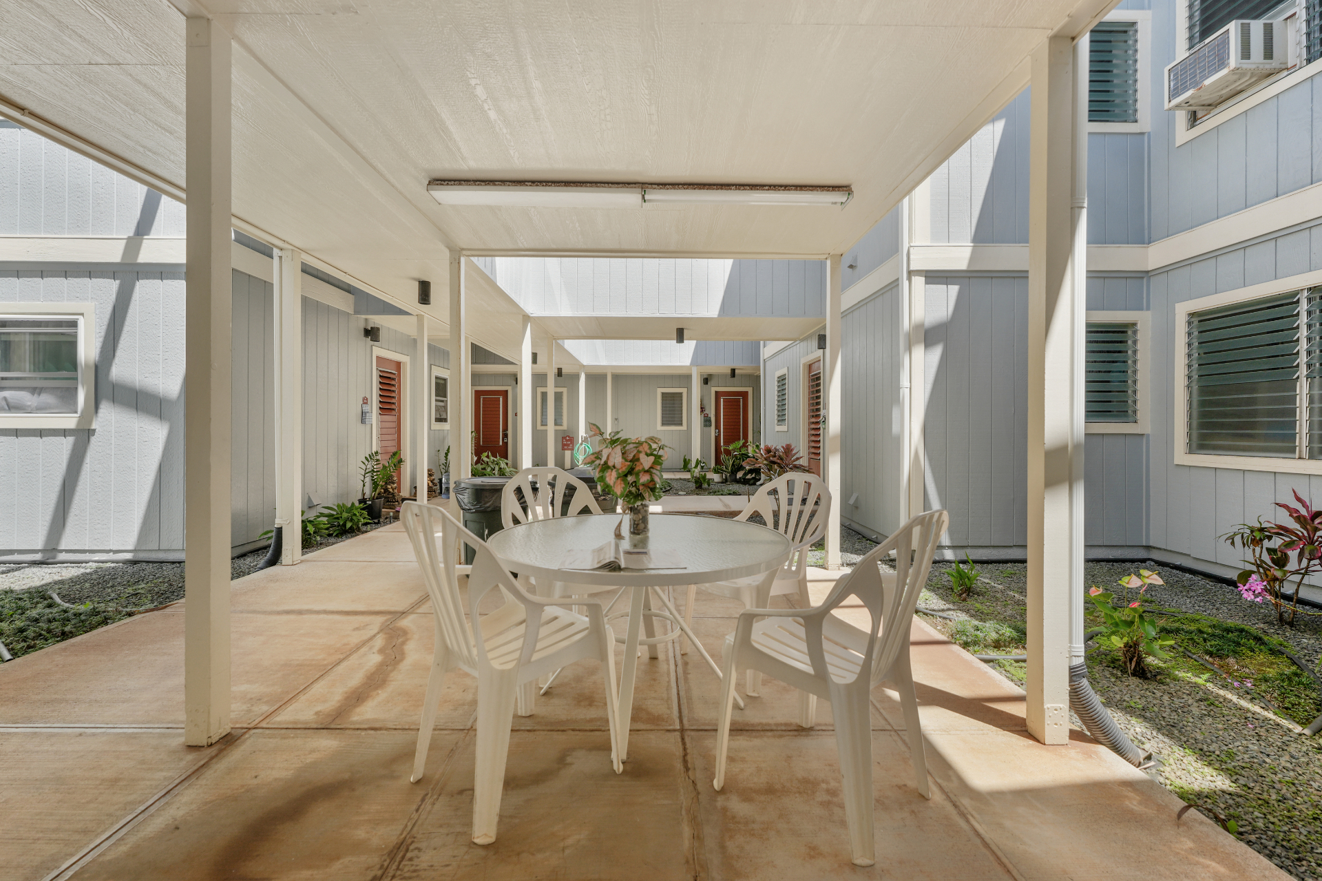 Shared interior courtyard with patio table and seating