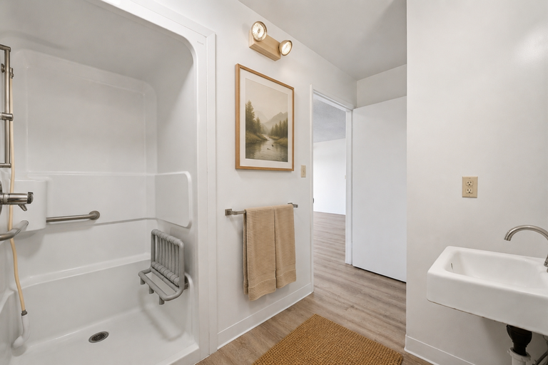 Walk-in shower with seat and towel rack